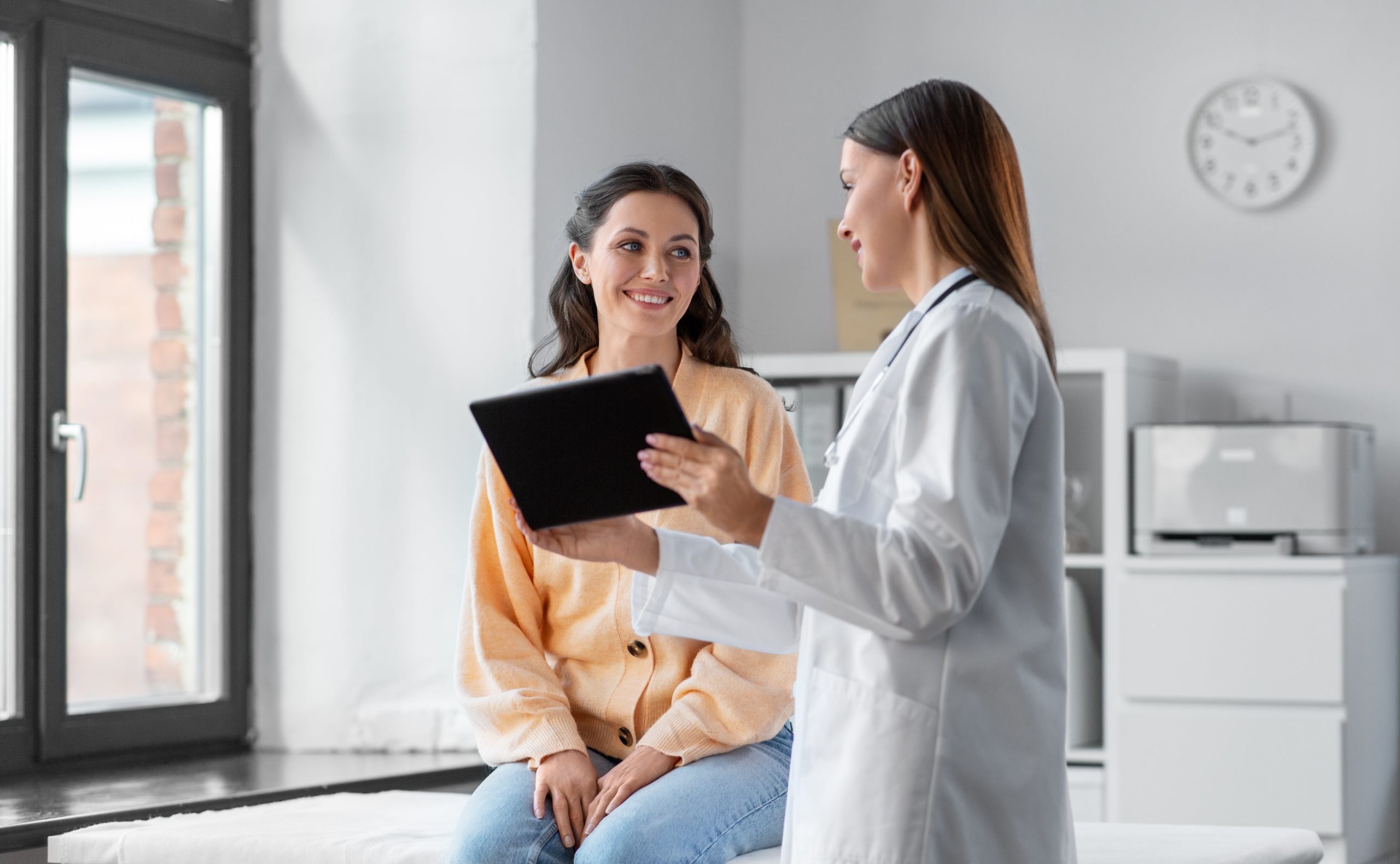 female doctors helping female patient